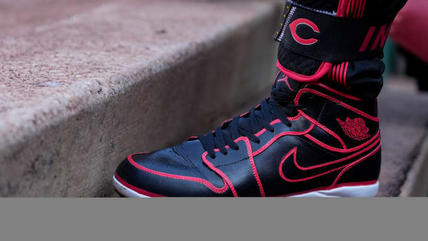 View of Jonathan India's black and red Air Jordan baseball cleats.